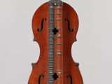 an old violin hanging from the ceiling with a guitar on it