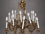 a large antique brass chandelier with twelve lights