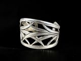 a close up of a silver ring on a black surface