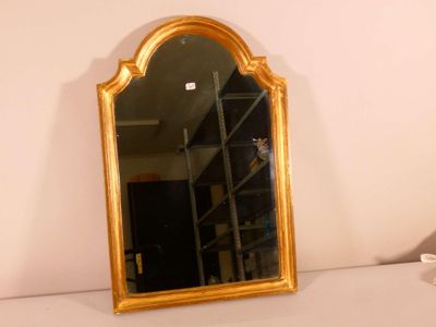 a mirror sitting on a shelf in the corner of a room