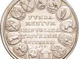 an image of a silver coin with symbols on it
