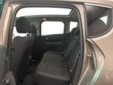 the back seats of a car with the door open and the driver ' s seat down