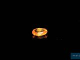 an orange sapphire in the dark with a black background