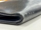 an image of a black leather wallet on a table