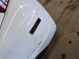 a close up of a white car with a sticker on it