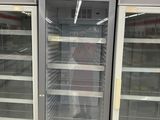 two refrigerators that are open in a store