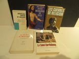 several books are sitting on a table next to each other