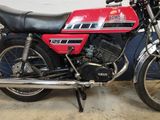 a red and black motorcycle parked in a garage