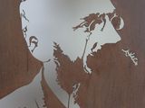 a picture of a man with a beard on a metal plaque