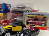 several toy cars are sitting on a table next to a box of toys