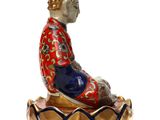 a figurine of a person sitting on a lotus flower