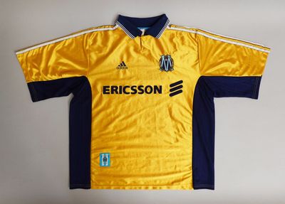 the shirt is yellow and blue with a white stripe on it