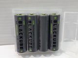 four batteries in a clear plastic case on a white surface