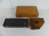 three wooden boxes are sitting next to each other on a white surface