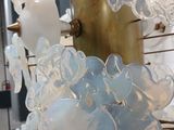 a close up of a glass chandelier hanging from a pole