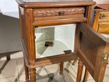 a small wooden table with a mirror on it