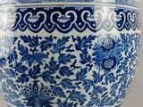 a large blue and white vase sitting on a table