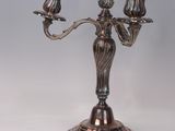 silver plated candelabra with three candles on a stand