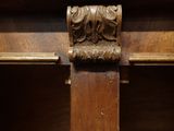 a close up of a wooden cross on a shelf in a church