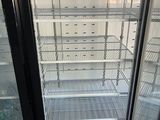 a refrigerator that is open and empty in the room