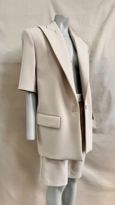 an image of a mannequin dressed in a beige suit