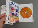 someone holding a nintendo wii game in a white case