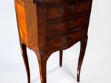 a small chest of drawers on a stand against a white background