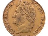 a close up of a gold coin with a woman ' s head on it