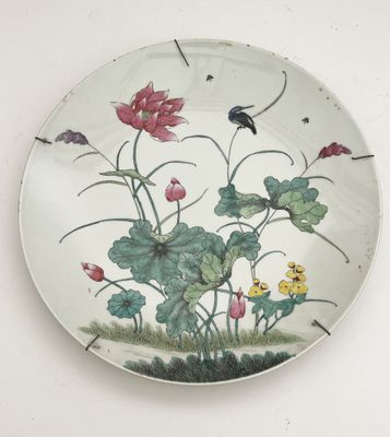 a plate with a painting of flowers and a bird on it