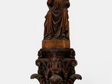 an antique carved wooden statue of a woman holding a child