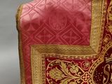 a close up of a red and gold vest on a mannequin