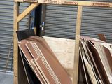 several pieces of wood are stacked on top of each other in front of a garage door