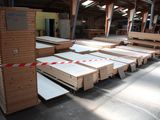 many stacks of wooden boards in a warehouse
