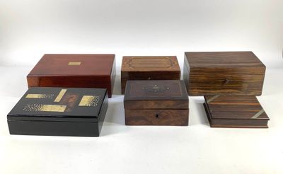 four wooden boxes are lined up on a white surface