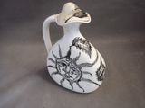 a white vase with a black and white design on it