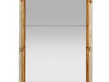 a large mirror with a gold frame and ornate design