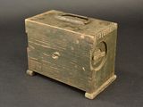 a small wooden box with a handle on a table