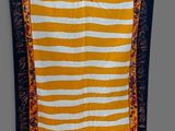 a yellow and white striped wall hanging with a sunflower on it