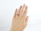 a woman ' s hand with a ring on it
