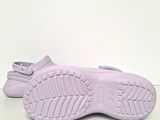 purple baby shoes with white soles on a white surface