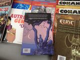 a lot of comic books sitting on a table