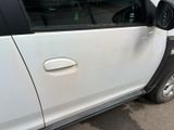 a white car that is parked on the side of the road