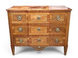 an antique chest of drawers with a wooden top and brass hardware