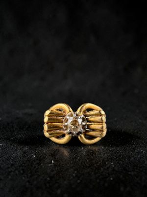 a close up of a pair of gold earrings with diamonds