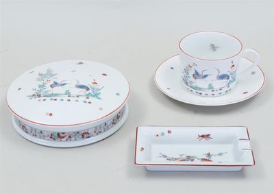 three pieces of porcelain dishes and a cup and saucer on a table