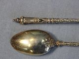 a silver spoon and a silver spoon on a table