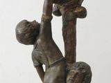 bronze statue of a boy holding a bowl with a bird on it