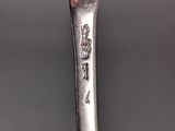 a close up of a spoon on a table with a black background