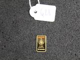 a gold bar with a tag attached to it