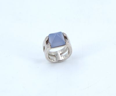 silver ring with a blue stone on a white background